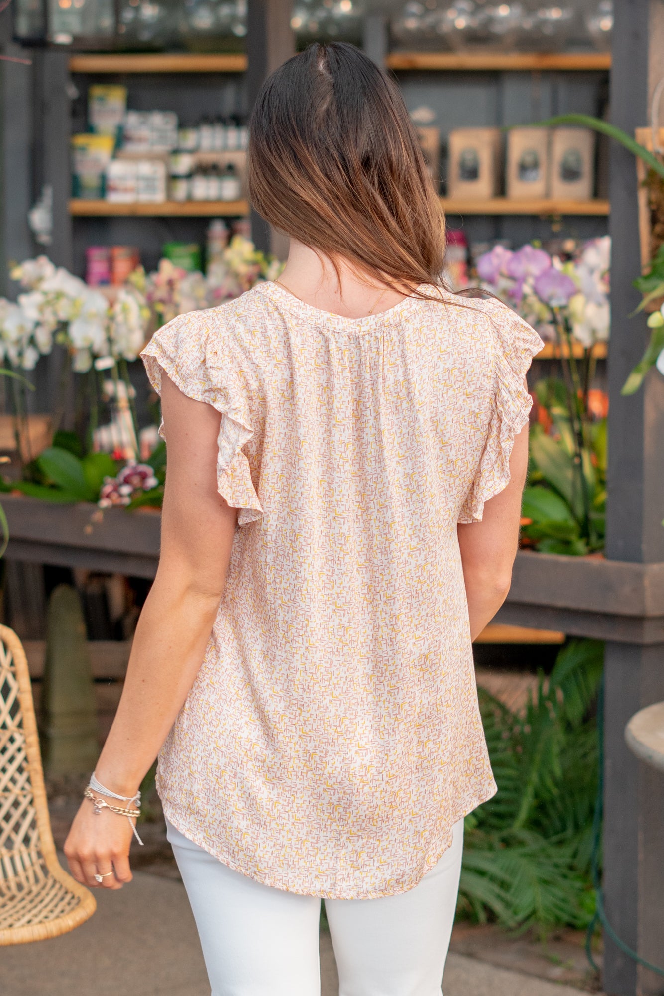 Ruffle Sleeve Top  Color: Neutral Coral Neckline: Button Down Sleeve: Flutter Sleeve Material: 100% Rayon Style #: 43000T-Neutral Orange Contact us for any additional measurements or sizing.  *Measured on the smallest size, measurements may vary by size.