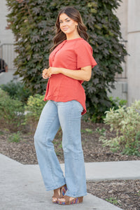 This short sleeve Henley top is great for layering up or down during winter and pairs well with any denim.  Color: Red Brick Button Up Front Henley Raglan Top Neckline: Round Sleeve: Short Sleeve 80% COTTON 20% POLYESTER Style #: FBT7658-A19-BrickRed Contact us for any additional measurements or sizing.