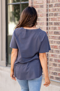 This short sleeve Henley top is great for layering up or down during winter and pairs well with any denim.  Color: Slate Grey Button Up Front Henley Raglan Top Neckline: Round Sleeve: Short Sleeve 80% COTTON 20% POLYESTER Style #: FBT7658-A19-Slategrey Contact us for any additional measurements or sizing.