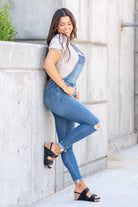 KanCan Jeans  98% Cotton 2% Spandex Medium Blue Cut: Skinny, 26.5" Inseam* Rise: High Rise, 10.25" Front Rise* Stitching: Classic Style #: KC7874M  Contact us for any additional measurements or sizing.  *Measured on the smallest size, measurements may vary by size.  Jacquelyn wears a size 25 in jeans, a small in tops, and 6.5 in shoes. She is wearing a size small in these overalls.