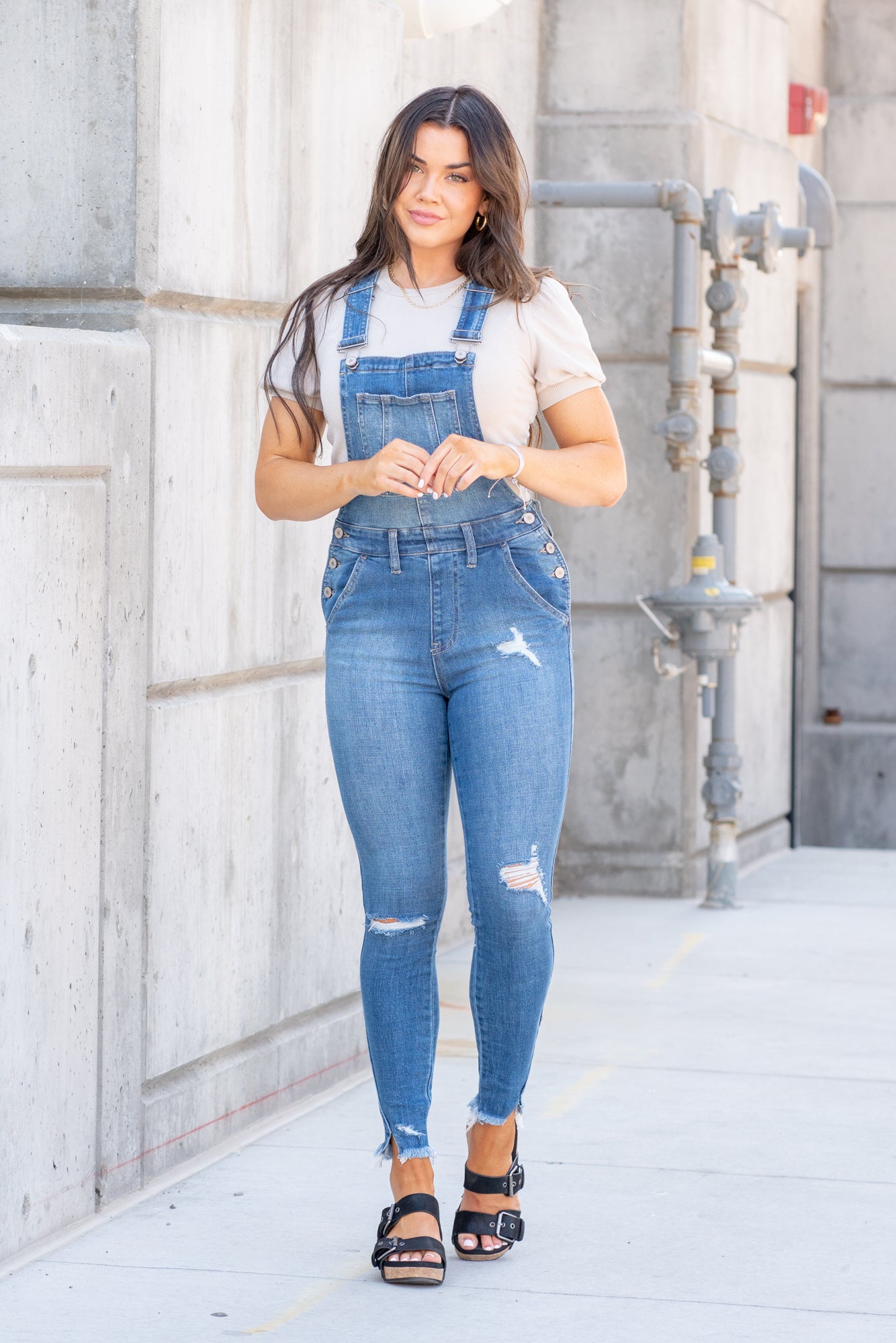 KanCan Jeans  98% Cotton 2% Spandex Medium Blue Cut: Skinny, 26.5" Inseam* Rise: High Rise, 10.25" Front Rise* Stitching: Classic Style #: KC7874M  Contact us for any additional measurements or sizing.  *Measured on the smallest size, measurements may vary by size.  Jacquelyn wears a size 25 in jeans, a small in tops, and 6.5 in shoes. She is wearing a size small in these overalls.