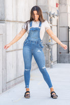 KanCan Jeans  98% Cotton 2% Spandex Medium Blue Cut: Skinny, 26.5" Inseam* Rise: High Rise, 10.25" Front Rise* Stitching: Classic Style #: KC7874M  Contact us for any additional measurements or sizing.  *Measured on the smallest size, measurements may vary by size.  Jacquelyn wears a size 25 in jeans, a small in tops, and 6.5 in shoes. She is wearing a size small in these overalls.