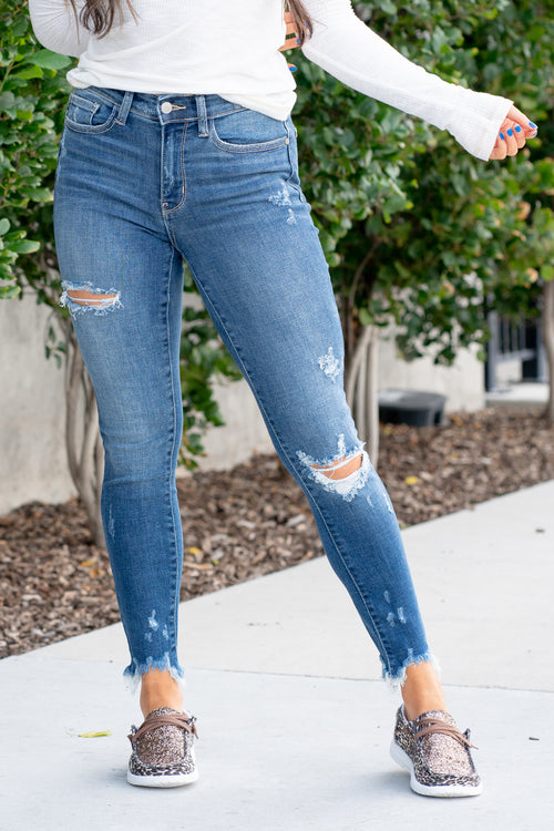 Judy Blue  Mid rise stretchy skinny jeans with a whiskered wash in dark blue with distressed legs and a frayed hem.  Color: Medium Wash  Cut: Skinny, 27" Inseam* Rise: Mid-Rise. 9.5" Front Rise* Material: 69% COTTON,16% POLYESTER,9% RAYON,5% ELASTRELL-POLY,1% SPANDEX Machine Wash Separately In Cold Water Stitching: Classic Fly: Zipper  Style #: JB82265-PL , 82265-PL