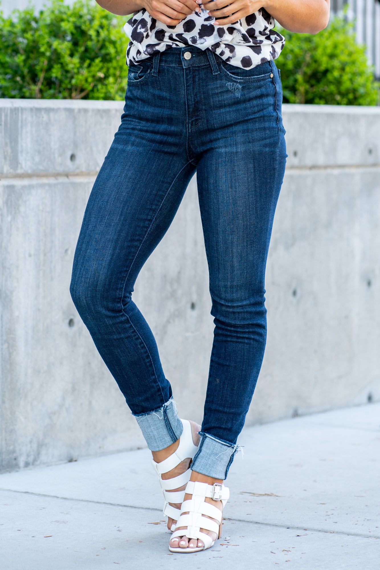 Judy Blue  A dark wash mid-rise skinny with a folded hem that can be unfolded to add length for longer inseams. Color: Medium Blue  Cut: Skinny fit, 28.5" Cuffed* | 32" Inseam Uncuffed* Mid Rise, 9.75" Front Rise* Material: 52% Cotton, 23% Polyester, 22% Rayon, 3% Spandex Stitching: Classic Fly: Zipper Fly Style #: JB82340 | 82340 Contact us for any additional measurements or sizing.    *Measured on the smallest size, measurements may vary by size.   