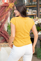Color: Marigold V Neck Fitted Short-Sleeved Style #: JBT7655-Marigold Contact us for any additional measurements or sizing.   *Measured on the smallest size, measurements may vary by size.  Alexis wears a size 25 in jeans, a small in tops, and 7 in shoes. She is wearing size small in this top. 