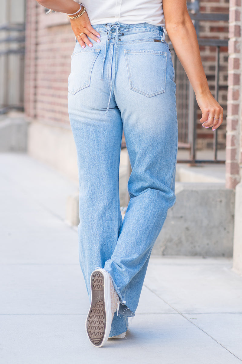 KanCan Jeans  KanCan Rigid Denim  Flare, 32" Inseam  High Rise, 12" Front Rise Light Blue Wash  100% Cotton Fly: Exposed Button Style #: KC8725L Contact us for any additional measurements or sizing.  *Measured on the smallest size, measurements may vary by size.  Jacquelyn wears a size 25 in jeans, a small in tops, and 6.5 in shoes. She is wearing a size 25 in these jeans.