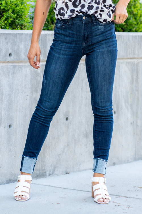 Judy Blue  A dark wash mid-rise skinny with a folded hem that can be unfolded to add length for longer inseams. Color: Medium Blue  Cut: Skinny fit, 28.5" Cuffed* | 32" Inseam Uncuffed* Mid Rise, 9.75" Front Rise* Material: 52% Cotton, 23% Polyester, 22% Rayon, 3% Spandex Stitching: Classic Fly: Zipper Fly Style #: JB82340 | 82340 Contact us for any additional measurements or sizing.    *Measured on the smallest size, measurements may vary by size.   