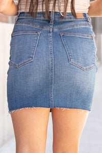 Judy Blue Jeans Color: Medium Blue Skirt  Cut: Shorts, 4" Inseam* Rise:  High Rise 10" Front Rise* Cotton Blend Stitching: Classic   Fly: Zipper Fly Style #: JB2800 | 2800 Contact us for any additional measurements or sizing.  *Measured on the smallest size, measurements may vary by size.  Jacquelyn wears a size 25 in jeans, a small in tops, and 6.5 in shoes. She is wearing a size small in this skirt.
