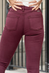 KanCan Jeans Color: Burgundy Red Cut: Super Skinny, 29" Inseam* Rise: High-Rise, 10" Front Rise* 57% COTTON, 35% MODAL, 6% POLYESTER, 2% SPANDEX Stitching: Classic Fly: Exposed Button Fly  Style #: KC9252BG Contact us for any additional measurements or sizing.    *Measured on the smallest size, measurements may vary by size.   Alyssa wears a size 25 in jeans, a small in tops, and 8 in shoes. She is wearing size 25 in these jeans. 