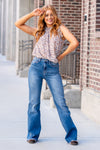 Flying Monkey Jeans  With comfortable stretch denim a fray hemline, these high-waisted and relaxed flares move with you. Features a cross-over button waistband and bell-bottom-styled legs.  Wash: Dark Blue Cut: Flare, 34" Inseam* Rise: High Rise, 11" Front Rise* 93% COTTON 5% POLYESTER 2% SPANDEX Stitching: Classic Fly: Zip Style #: F4511 Contact us for any additional measurements or sizing. 