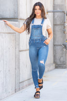 KanCan Jeans  98% Cotton 2% Spandex Medium Blue Cut: Skinny, 26.5" Inseam* Rise: High Rise, 10.25" Front Rise* Stitching: Classic Style #: KC7874M  Contact us for any additional measurements or sizing.  *Measured on the smallest size, measurements may vary by size.  Jacquelyn wears a size 25 in jeans, a small in tops, and 6.5 in shoes. She is wearing a size small in these overalls.