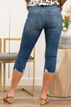 KanCan Jeans Collection: Spring 2021 Color: Dark Wash High Rise Fray Hem Cut: Skinny Capris, 16" Inseam Rise: High-Rise, 10" Front Rise 68%COTTON 30%POLYESTER 2%SPANDEX Stitching: Classic  Fly: Zipper Fly Style #: KC8622D Contact us for any additional measurements or sizing.  Kristin wears a size small top, a 3 in jeans, and a 7 in shoes. She is wearing a size 25/3 in these jeans.