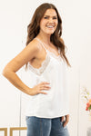 Pair this silky camisole under your favorite cardis or dusters.  Collection: Spring 2021 Color: Off White Neckline: V Neck Lace Material: 96% Polyester 4% Spandex Style #: IP0065 Contact us for any additional measurements or sizing.  Kristin wears a size small top, a 3 in jeans, and a 7 in shoes. She is wearing a size small in this camisole.