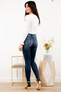 KanCan Jeans Collection: Spring 2021 Color: Dark Wash Distressed Fray Hem Cut: Skinny, 28.5" Inseam Rise: High-Rise, 10.5" Front Rise COTTON 94.3% T400 4.9% SPANDEX 0.8% Stitching: Classic Fly: Exposed Button Fly  Style #: KC7310D Contact us for any additional measurements or sizing.  Chloe is 5’8" and 130 pounds. She wears a size 3 in jeans, a small top, and 8.5 in shoes. She is wearing a size 25/3 in these jeans.