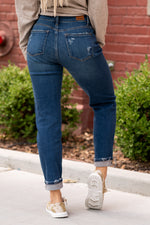Judy Blue  These mid-waisted slim fit will be your comfiest Judy Blues yet! With relaxed legs and a mid-waist, you will want to wear these every day!   Color: Dark Blue Cut: Boyfriend, 27.5" Inseam Cuffed Rise: Mid Rise. 9.5" Front Rise Material: 93% COTTON,6% POLYESTER,1% SPANDEX Machine Wash Separately In Cold Water Stitching: Classic Fly: Zipper Style #: JB82334 , 82334 Contact us for any additional measurements or sizing.