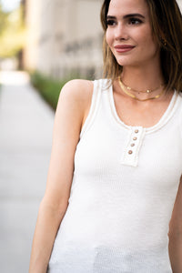This sleeveless Henley top is great for layering up or down during spring & summer and pairs well with any denim.  Collection: Spring 2021 Color: White Button Up Front Henley  Neckline: Round Sleeve: Sleeveless  Material: 60% POLYESTER/32% COTTON/8% SPAN Style #: JAT7478-White Contact us if you have any questions about sizing or fit.
