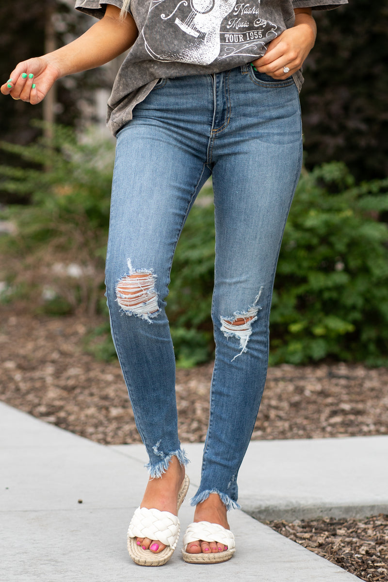 Sneak Peek Denim  These sneak peek jeans have an amazing high-rise skinny fit.  Collection: Spring 2021 Tomboy Skinny Color: Medium Blue Cut: Flares, 29" Inseam Rise: Mid-Rise, 10.5" Front Rise 71% Cotton 15% Rayon 12% Polyester 2% Spandex Fly: Zipper   Style #: SP-P11439 Contact us for any additional measurements or sizing.'