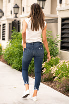 KanCan Jeans These high rise dark wash skinny jeans have a distressed fray hem and fit above the ankles so you can show off you sandals this summer. Color: Dark Blue Cut: Skinny, 27" Inseam Rise: High-Rise, 10" Front Rise 82.5% COTTON , 11.5% VISCOSE , 4.5% POLYESTER , 1.5% SPANDEX Stitching: Classic  Fly: Zipper Style #: KC7147D Contact us for any additional measurements or sizing.