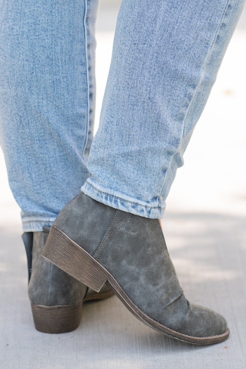 Booties | Very G  These booties from Very G are perfect to wear with boot-cut jeans this fall. The look of a boot without the extra heat from a covered ankle.  Style Name: Juliana  Color: Grey Cut: Silp On Bootie   Rubber Sole Style #: VGLB0277 Contact us for any additional measurements or sizing.