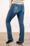 Miss Me  Wear these M logo pockets jeans every day to bling up your wardrobe. Boot cut jeans featuring a 5 pocket design, whiskering, and crystal rivets. Wash: Dark Blue Inseam: 34" Boot Cut* Mid Rise, 8.75" Front Rise* Silver Buttons and Rivets  Material: 93% Cotton 5% Polyester 2% Elastane Style #: M3817B3   Contact us for any additional measurements or sizing.    *Measured on the smallest size, measurements may vary by size.   