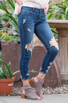 Cello Jeans  Step into style with these open knee skinny jeans! The light denim open knee skinny features distressed detail throughout, light whisker detail, and a mid-rise waist. They have five pockets and a zip fly closure. Color: Dark Blue  Cut: Skinny, 26.5" Inseam Rise: Mid-Rise, 8.25" Front Rise 98% COTTON 2% SPANDEX Fly: Zipper   Style #: WV15329C-DK