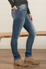 Miss Me  Stay in the spotlight with this adorable pair of skinny jeans detailed with an embroidered yoke. Wash: Dark Blue Inseam: 30" Skinny Cut Mid Rise, 8.5" Front Rise Silver Buttons and Rivets Style #: M3444S49 Contact us for any additional measurements or sizing.  *Measured on the smallest size, measurements may vary by size. 