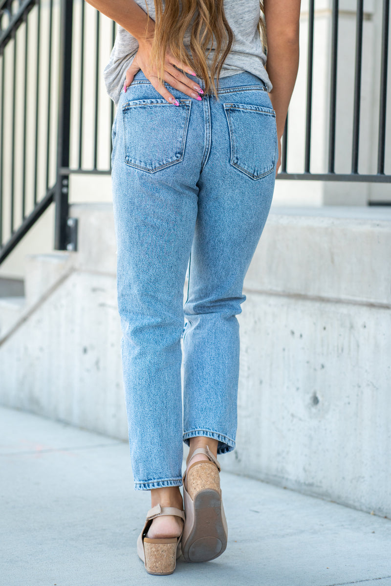 KanCan Jeans  These mom jeans will become your go-to! Pair these girlfriend mom fit with chunky sandals and a tee for an easy summer look.  Color: Medium Blue Cut: Straight Fit, 27" Inseam* Rise: High-Rise, 10.75" Front Rise* 100% Cotton Fly: Zipper Style #: KC8662M Contact us for any additional measurements or sizing.  *Measured on the smallest size, measurements may vary by size.