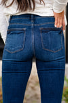 Judy Blue  These distressed hem relaxed fit jeans will be your comfiest Judy Blues yet! With relaxed legs and a mid-waist, you will want to wear these every day!   Color: Dark Blue Cut: Relaxed Fit, 27" Inseam* Rise: Mid Rise. 9.5" Front Rise* Material: 66% COTTON,21% POLYESTER,11% RAYON,2% SPANDEX Machine Wash Separately In Cold Water Stitching: Classic Fly: Zipper Style #: JB82227 , 82227  Contact us for any additional measurements or sizing. 