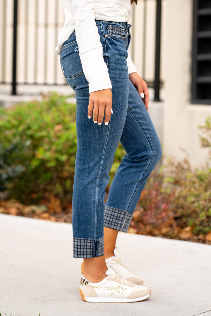 Judy Blue  These mid-waisted slim fit jeans will be your comfiest Judy Blues yet! With relaxed legs and plaid cuffed hem, you will want to dress these up!   Color: Dark Blue Cut: Boyfriend, 28.5" Inseam  Rise: Mid Rise. 9.5" Front Rise Material: 66% COTTON,21% POLYESTER,11% RAYON,2% SPANDEX Machine Wash Separately In Cold Water Stitching: Classic Fly: Zipper Style #: JB88358 , 88358 Contact us for any additional measurements or sizing.   *Measured on the smallest size, measurements may vary by size. 