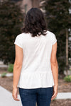 Hem & Thread   This peplum top has an oversized fit with a cross-over look. With a textured gauze material, you will feel comfortable and cute. Pair with your favorite jeans and booties for an early fall vibe.   Neckline: Round Sleeve: Short  69% POLYESTER 30% RAYON 1% SPANDEX Style #: 30868F-White Contact us for any additional measurements or sizing.