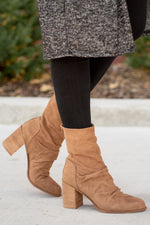 Boots by Oasis Society  These scrunched boots with zipper closures and block heels are great with skinny jeans and oversized cardigans this fall.  Color: Camel Man-made Upper Leather Wrap heel Padded footbed Shaft Height: 6.75" Heel Height: 3.25" Contact us for any additional measurements or sizing. 