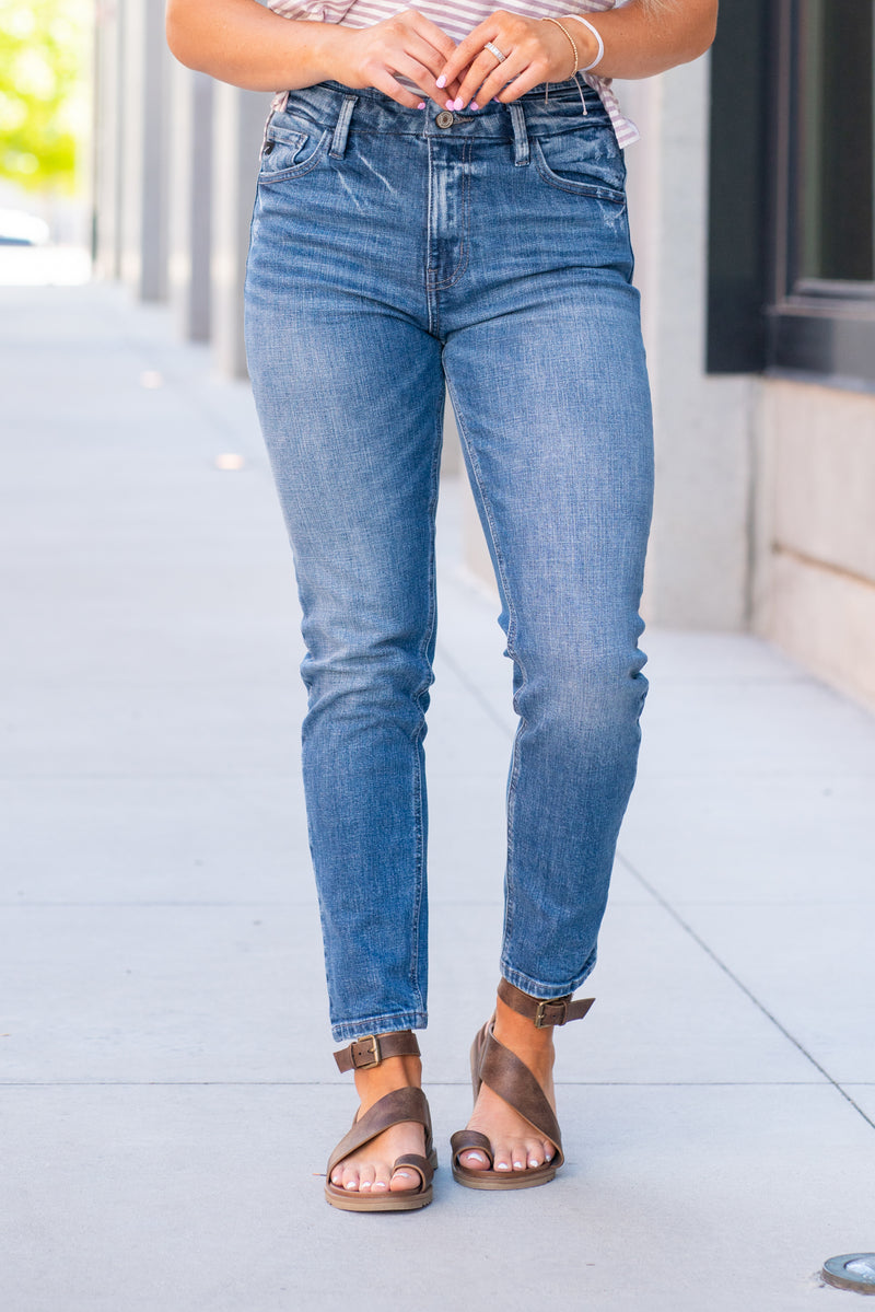 KanCan Jeans  With a high waist and mom fit, these will be your go-to jeans that will never go out of style. Color: Medium Blue  Cut: Mom Fit, 28" Inseam* Rise: High-Rise, 10.5" Front Rise* 98% Cotton 2% Spandex  Fly: Zipper Style #: KC8671M Contact us for any additional measurements or sizing.  *Measured on the smallest size, measurements may vary by size.