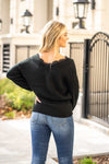 Hem & Thread   This sweater is perfect for dressing up fall. With a lace-trimmed neckline and ribbed material, you will feel comfortable and cute. Pair with your favorite jeans and booties for an early fall vibe.   Neckline: V Front & Back Sleeve: Long  100% Acrylic Style #: 31019-Black Contact us for any additional measurements or sizing.