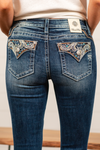 Miss Me  Wear these destroyed paisley pocket jeans every day to bling up your wardrobe. Boot cut jeans featuring a 5 pocket design, whiskering, and crystal rivets. Wash: Dark Blue Inseam: 34" Boot Cut* Mid Rise, 8.75" Front Rise* Silver Buttons and Rivets  Style #: M3815B   Contact us for any additional measurements or sizing.    *Measured on the smallest size, measurements may vary by size.   
