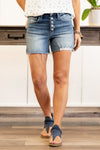 VERVET by Flying Monkey Jeans    This comfortable high rise shorts have a distressed front and hem detail with an exposed button fly. Pair with a graphic tee and sandals. Collection: Spring 2021 Shorts, 4" Inseam  High Rise, 9" Front Rise 93% COTTON 5% POLYESTER 2% SPANDEX Stitching: Classic Fly: Exposed Button Fly  Style #: VT1041 Contact us for any additional measurements or sizing.  Kristin wears a size small top, a 3 in jeans, and a 7 in shoes. She is wearing a size small in these shorts.