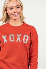 XOXO by Oat Collective   Graphic Fleece Pullover Relaxed Fit Crop   Color: Brick Red Neckline: Round  Sleeve: Raglan Long Sleeve Spun from plush sponge fleece fabric Ribbed Cuffed Wrist Bands Oversized Pull Over Style #: OT2112L685  Contact us for any additional measurements or sizing.      