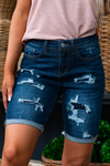 Judy Blue Jeans Color: Dark Blue Shorts   Cut: Bermudas Shorts, 8.5" Inseam  Rise: 10.5" Front Rise 91% COTTON,7% POLYESTER,2% RAYON Stitching: Classic  Fly: Zipper Fly Style #: JB150115-DK | 150115-DK Contact us for any additional measurements or sizing.  *Measured on the smallest size, measurements may vary by size. 