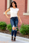 Cello Jeans  Classic blue wash mom jeans cut in a slim-fit silhouette that hits at the ankles for easy wear. Fashioned with a high-waisted, figure-flattering fit, and made from a cotton-blend fabric for comfortable year-round wear. Additionally crafted with distress detail, five pockets, belt loops, and a zip fly closure.