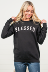 Blessed by Oat Collective   Graphic Fleece Pullover Sweater  Color: Black Neckline: Round  Sleeve: Long Sleeve Spun from plush sponge fleece fabric Ribbed Cuffed Wrist Bands Oversized Pull Over Style #: OT2112L711 Contact us for any additional measurements or sizing.    