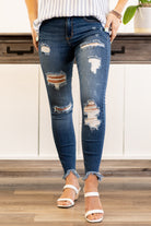 Cello Jeans  Featuring distressed detailing throughout keeps this pant edgy and chic. Additionally the unique step hem adds a fun twist in your everyday jeans. Crafted with five pockets, belt loops and a zip fly closure. Collection: Spring 2021 Color: Medium Blue Wash  Cut: Crop Ankle Skinny, 27" Inseam Rise: Mid-Rise, 9.5" Front Rise 77% Cotton 18% Polyester 4% Rayon 1% Spandex Fly: Zipper Style #: WV77638M Contact us for any additional measurements or sizing.