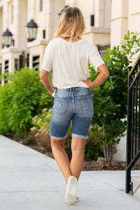 High Rise Cuffed Hem Bermuda Shorts  By KanCan   Collection: Spring 2021 High-rise waist, 10" Front Rise Cut: Bermudas, 11" Inseam Functional pockets Whiskered Washed Denim, Blue Wash Stitching: Classic Fly: Zip Style #: KC9266M Contact us for any additional measurements or sizing. 