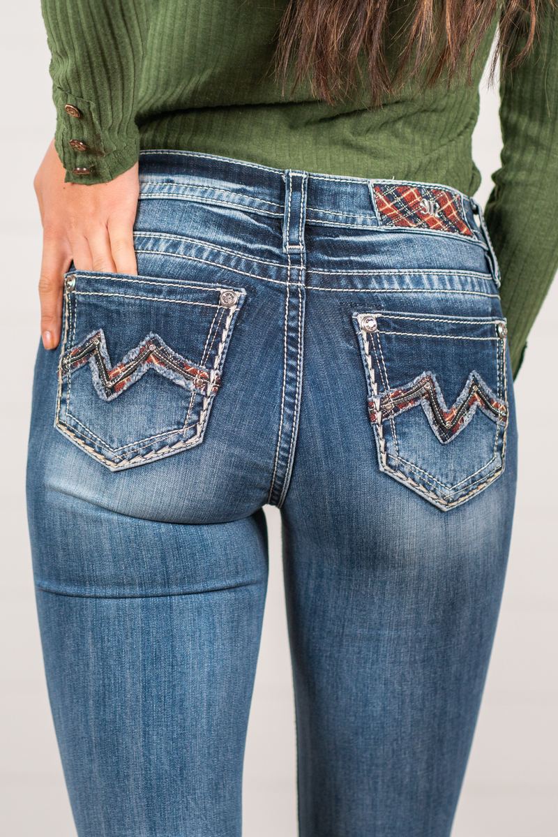 Miss Me  Wear these Christmas plaid pocket jeans every day to bling up your wardrobe. Boot cut jeans featuring a 5 pocket design, whiskering, and crystal rivets. Wash: Dark Blue Inseam: 34" Boot Cut* Mid Rise, 8.75" Front Rise* Silver Buttons and Rivets  Style #: M3742B5    Contact us for any additional measurements or sizing.    *Measured on the smallest size, measurements may vary by size.   