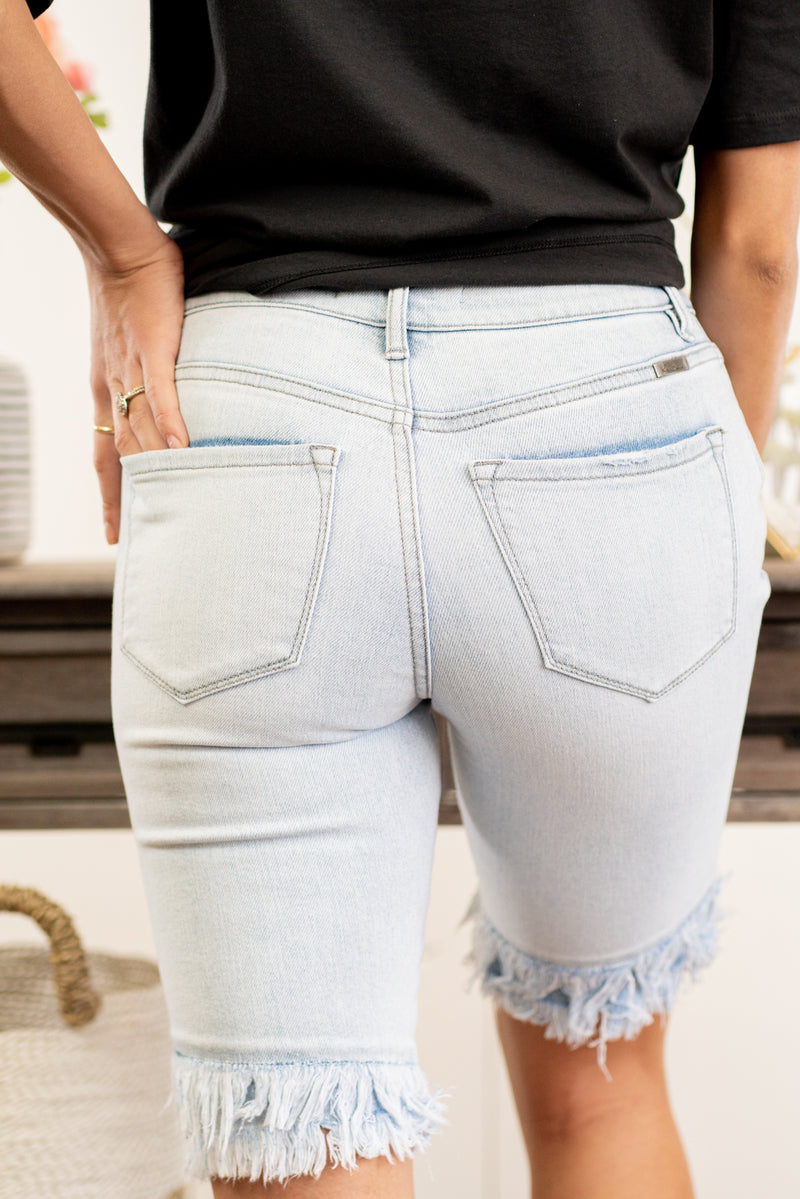 High Rise Fringe Hem Shorts  By KanCan   Collection: Spring 2021 High-rise waist, 10" Front Rise Cut: Bermudas, 11" Inseam Functional pockets Whiskered Washed Denim, Blue Wash Material: 94.2% COTTON, 4.7% POLYESTER, 1.1% SPANDEX Stitching: Classic Fly: Zip Style #: KC7165L Contact us for any additional measurements or sizing.