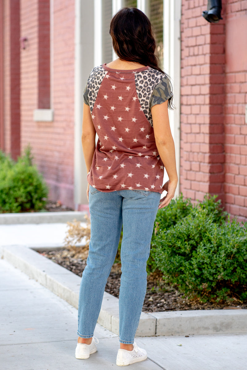 BiBi  This is a must have top! Leopard, camo and star printed color block. Color: Red Neckline: Round Sleeve: Short Sleeve Material: Cotton/Poly Style #: BT1793 Contact us for any additional measurements or sizing.