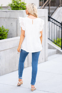 BiBi   Dress up your denim with this ruffle sleeve top.  Collection: Spring 2021 Color: White Neckline: Round Sleeve: Short   Style #: IP4055 Contact us for any additional measurements or sizing. 