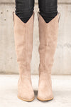 Boots by Oasis Society  A western knee high boot with a zipper and block heel with a v cut to elongate the legs. Color: Taupe Man-made Upper Leather Wrap heel Padded footbed Shaft Height: 15" Heel Height: 2" Contact us for any additional measurements or sizing. 