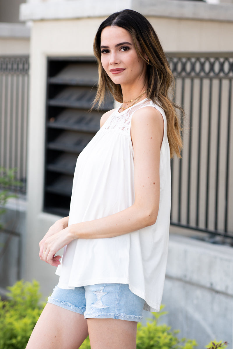Miss Sparkling  Pair this tank with skinny jeans and strappy sandals for a perfect summer look.  Collection: Spring 2021 Color: White Neckline: High Round Neck Sleeve: Tank 100% Polyester  Style #: D2050486 Contact us for any additional measurements or sizing.  