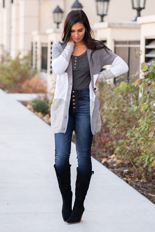 Miss Sparkling  Pair this knit cardi with tall boots and your favorite dress up jeans for an effortless dressed up look.  Collection: Winter 2020 Color: Grey Neckline: Open Neck Sleeve: Long Sleeve 100%Acrylic Style #: O205005-Grey Contact us for any additional measurements or sizing.  Chloe is 5’8" and 130 pounds. She wears a size 26 in jeans, a small top and 8.5 in shoes. She is wearing a size small in this cardigan. 