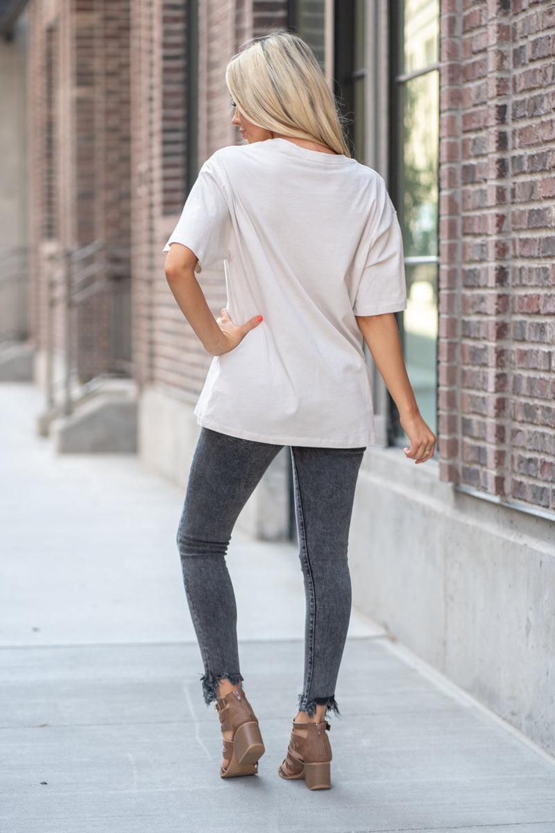 Zutter  Every great dream begins with a dreamer. Flaunt your sass in this cute tee.  Collection: Fall 2020 Color: Light Khaki Neckline: Round Sleeve: Short Material: 100% Cotton Style #: F525-7476 Contact us for any additional measurements or sizing.  Haley is 5’6" and wears size 25 in jeans, a small top and 7.5 in shoes. She is wearing a size small in this top.