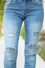 KanCan Jeans Collection: Fall 2020 Color: Medium Wash Skinny, 29.5" Inseam  Mid Rise, 8.5" Front Rise Leopard Patch Backed Distress  92% Cotton 6% Polyester 2% Spandex  Fly: Zipper Style #: KC6307D Contact us for any additional measurements or sizing.